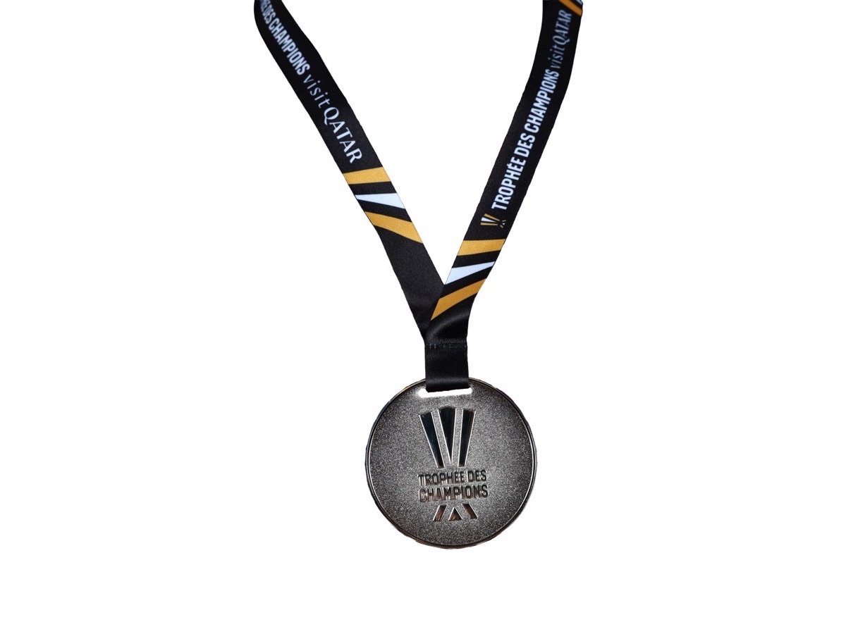 Médaille du Trophée des Champions 2024-2025 sur son ruban, sur fond blanc